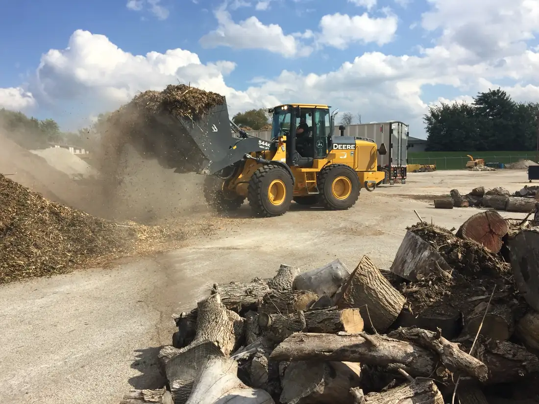 Turning wood waste into mulch.